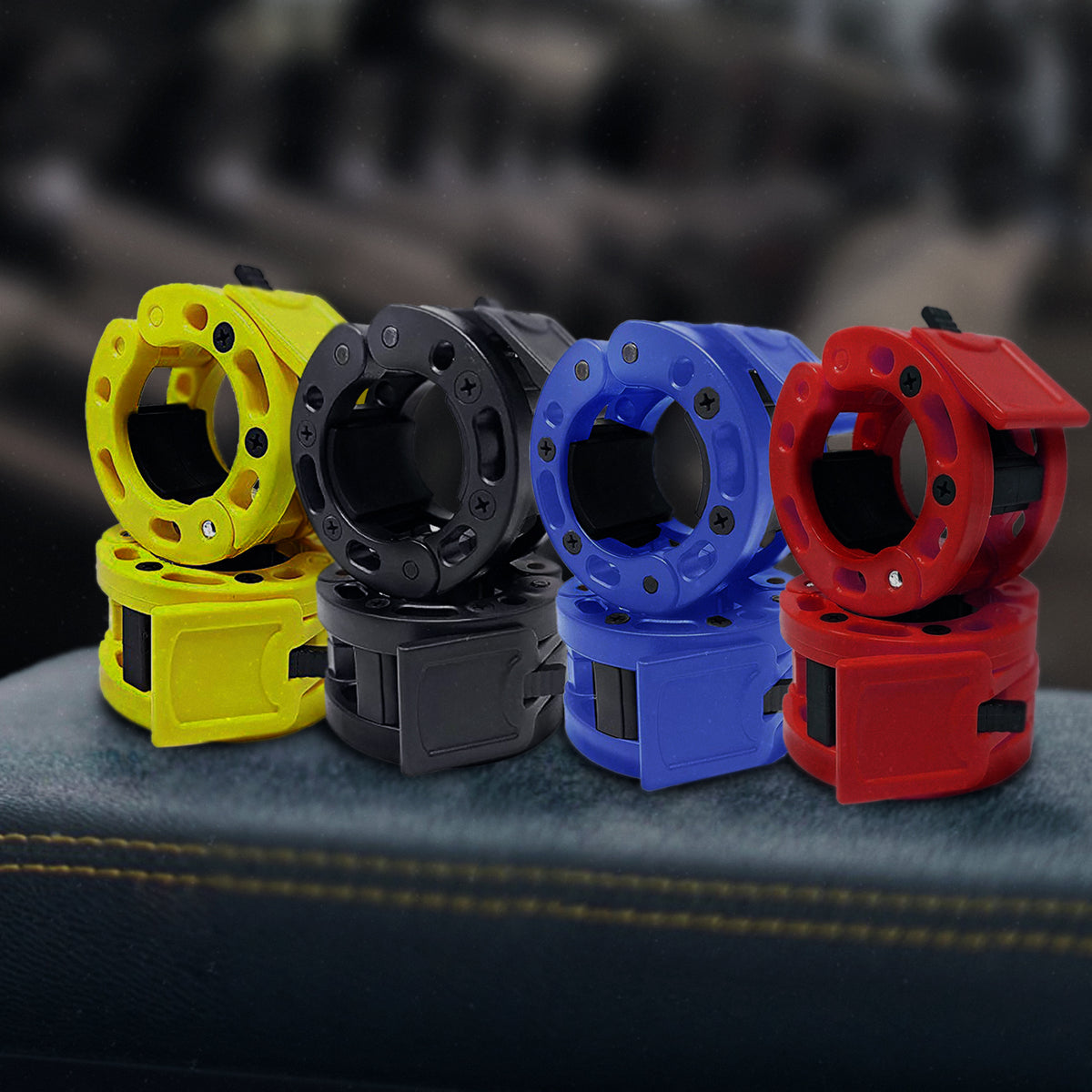 Clout barbell clamps in yellow, black, blue, and red
